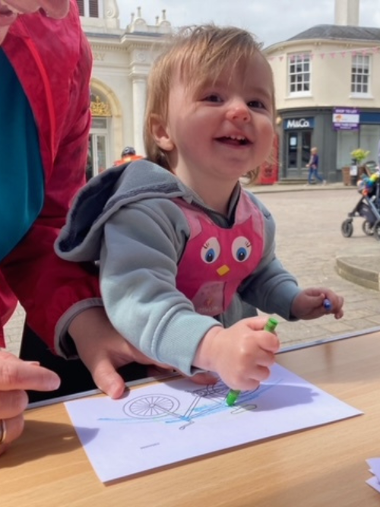 Toddler colouring in smiling