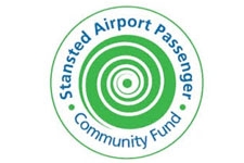SAPCF logo featuring a white spiral on a green background surrounded by text